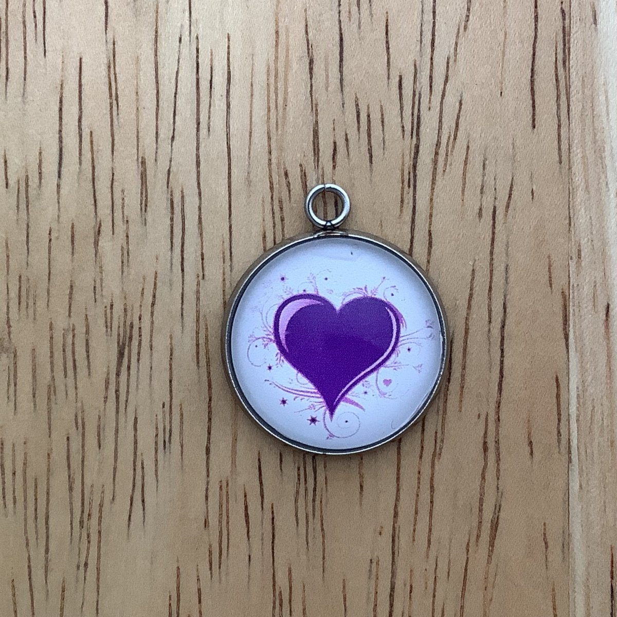 purple heart with swirls around it