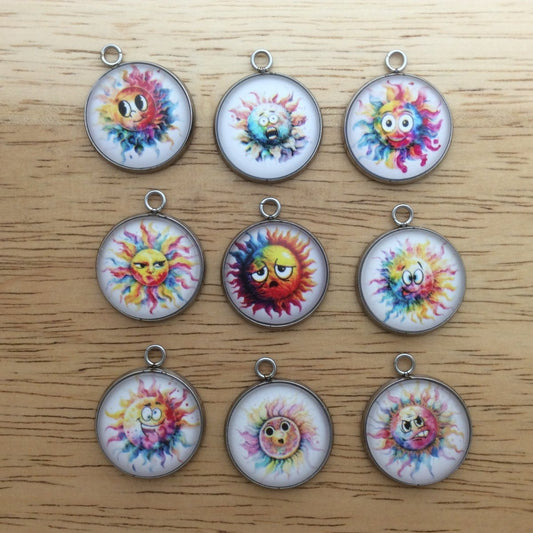 9 glass cabochon charms with images of rainbow colored sun with funny faces