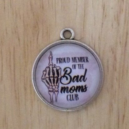 glass cabochon charm with a skeleton hand showing the middle finger and says proud member of the bad moms club