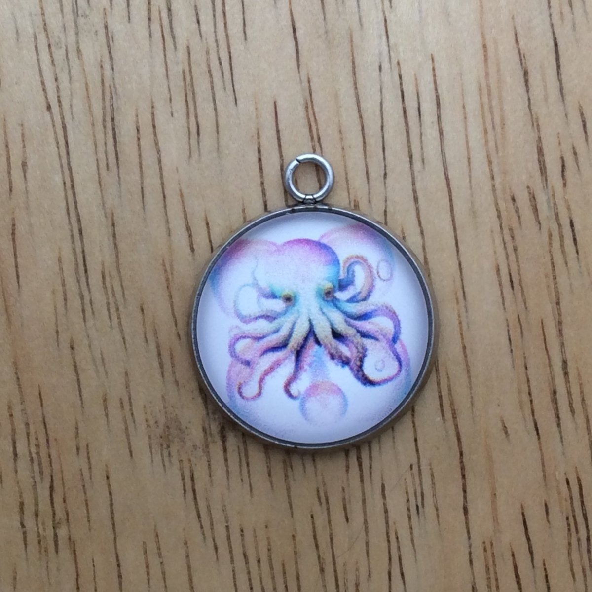 glass cabochon charm with a picture of an octopus