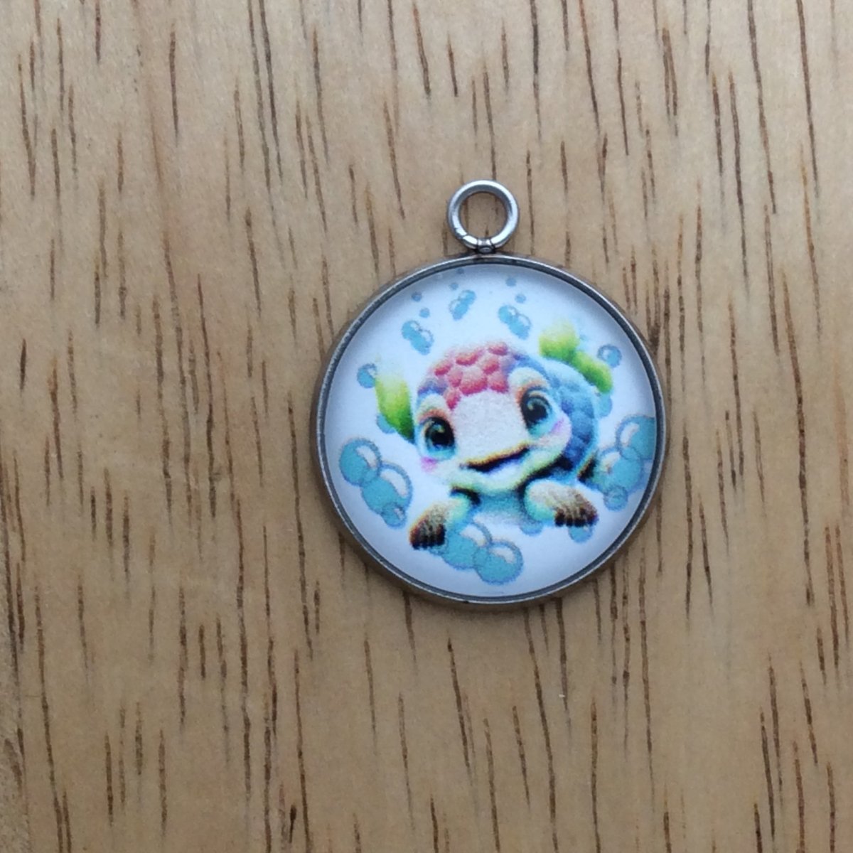 glass cabochon charm with a picture of a sea turtle