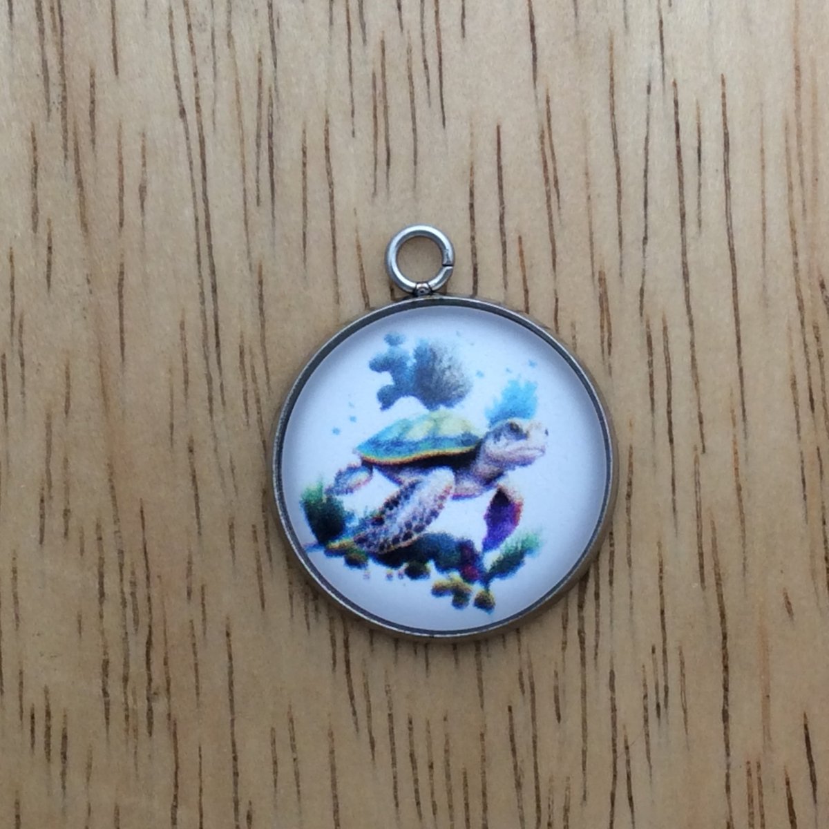 glass cabochon charm with a picture of a sea turtle