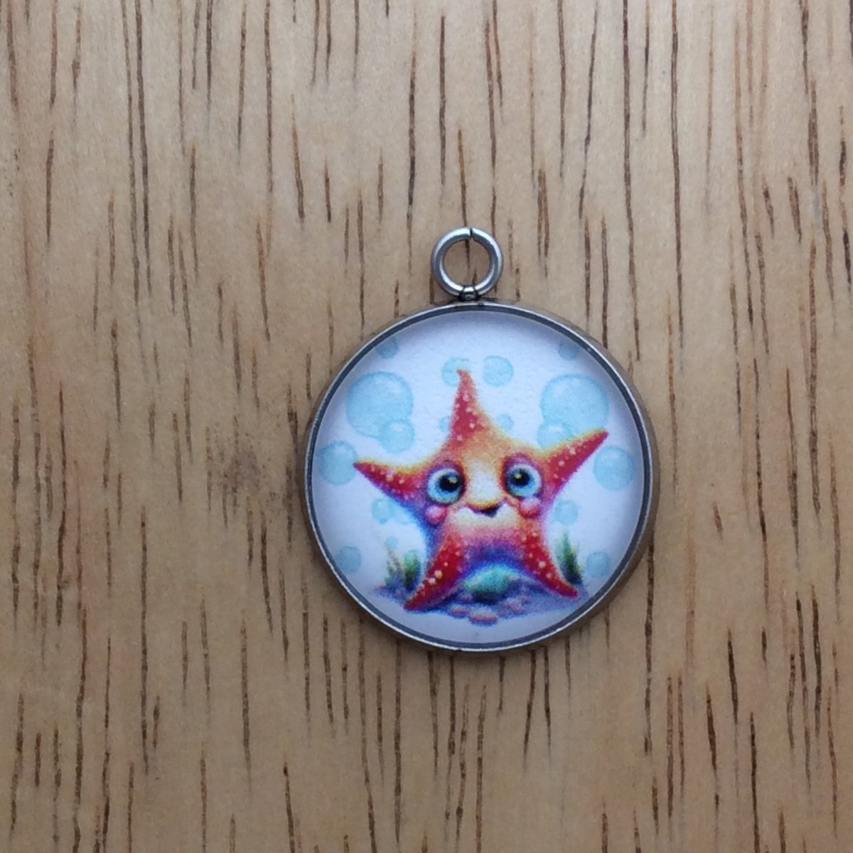 glass cabochon charm with a picture of a starfish