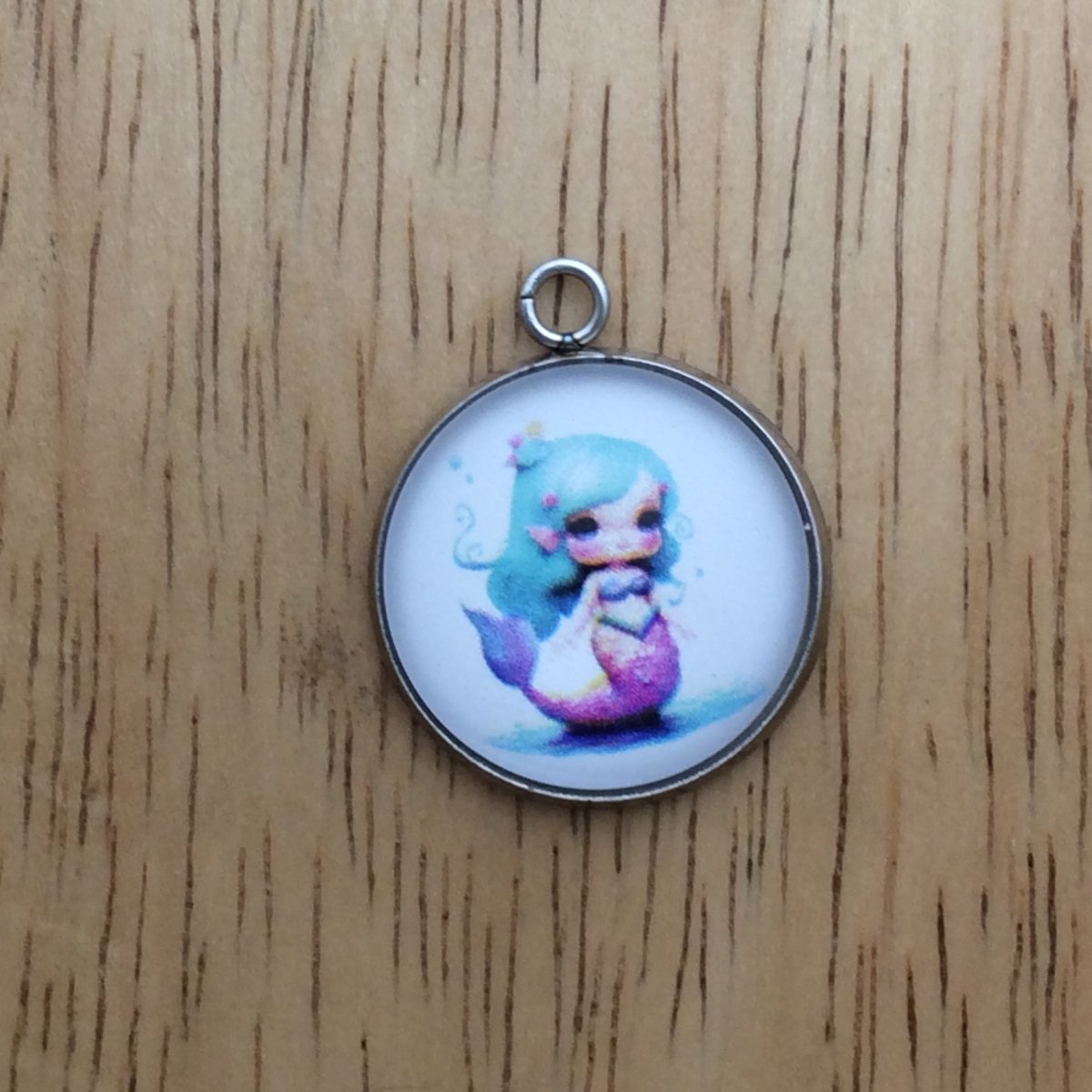 glass cabochon charm with a picture of a mermaid