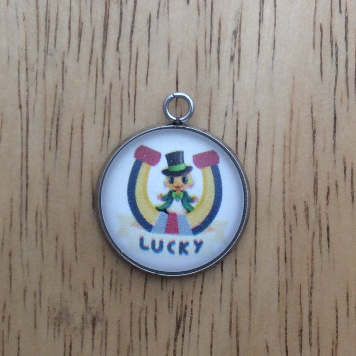 glass cabochon charm with a duck in a lucky horseshoe