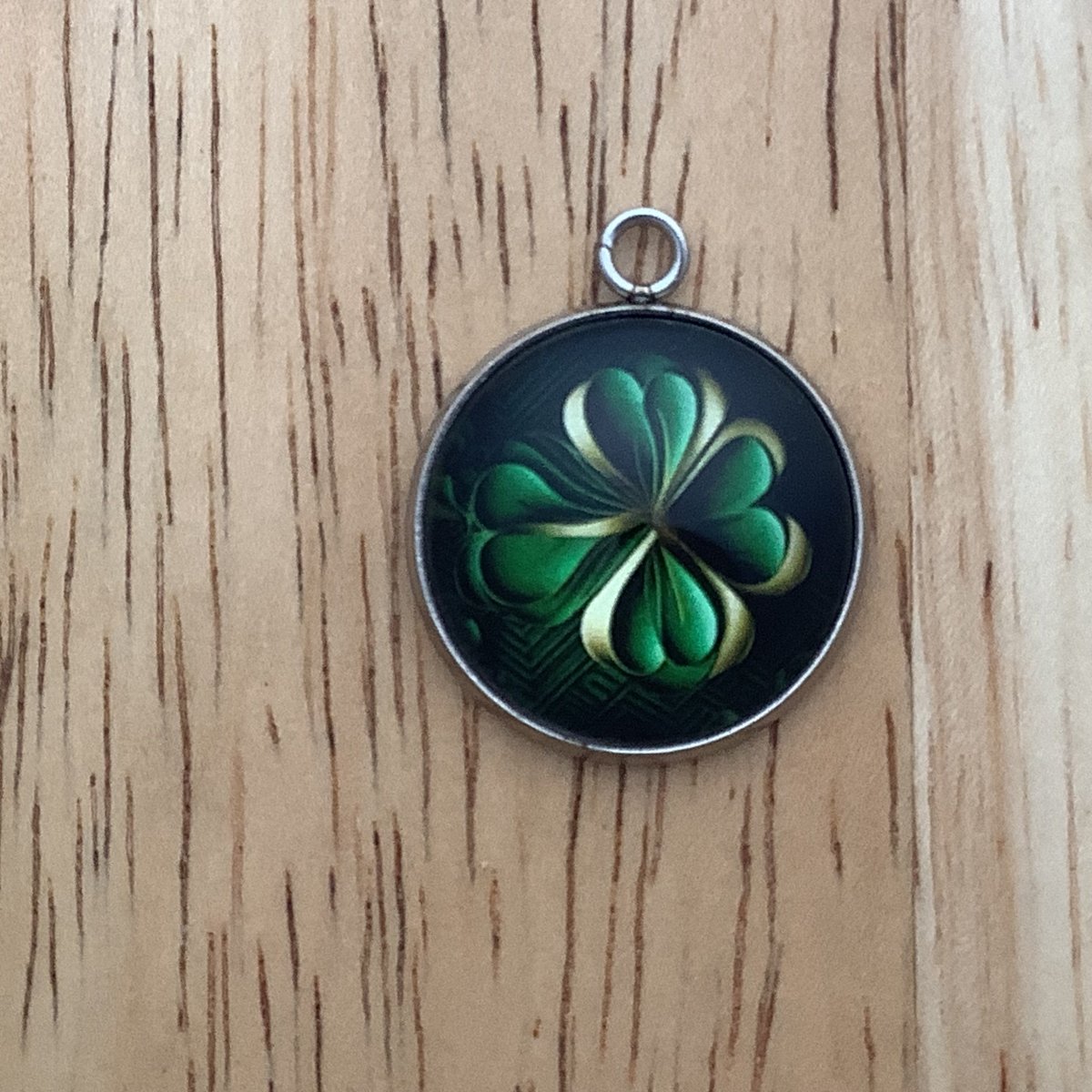 4 green leaf clover with a lighter green/yellowish one behind on a black background 