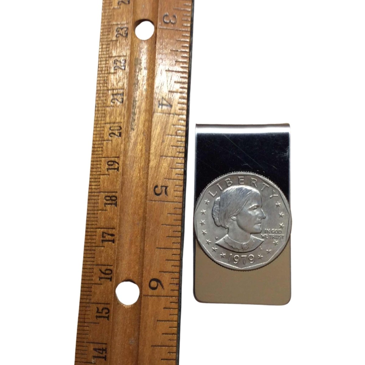 stainless steel 1979 suzan b Anthony money clip next to a ruler for sizing