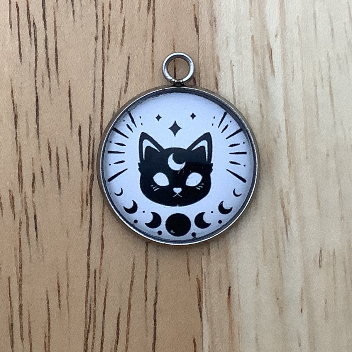 moon phases with a black cat head charm