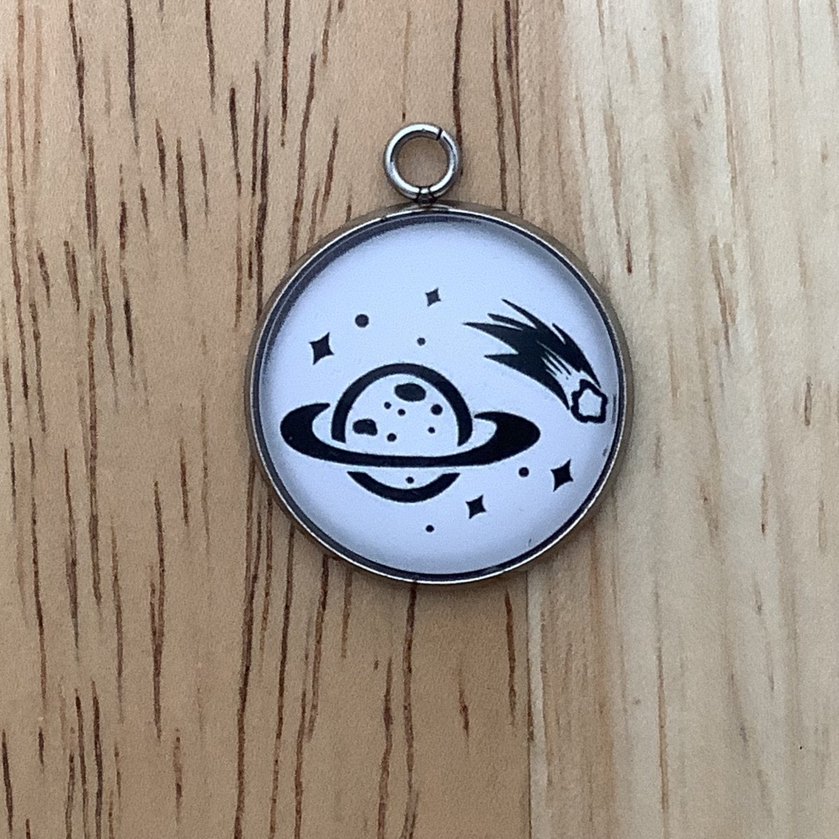 a planet with a shooting asteroid Charm