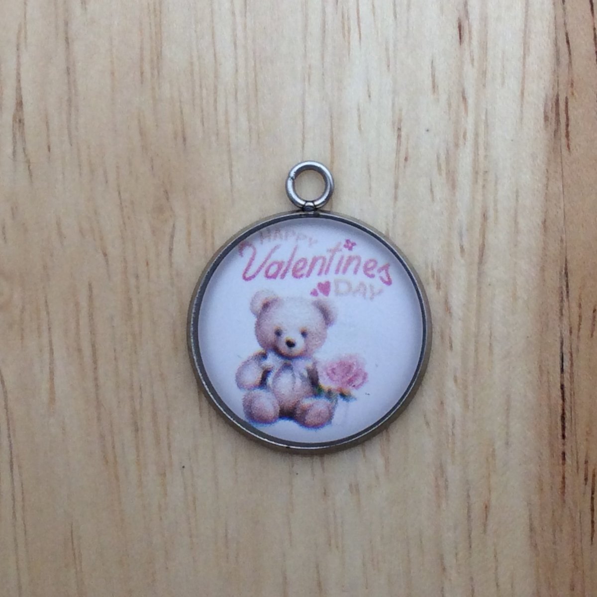 One glass cabochon charm that says Happy Valentines Day, with a Teddy bear holding a pink rose