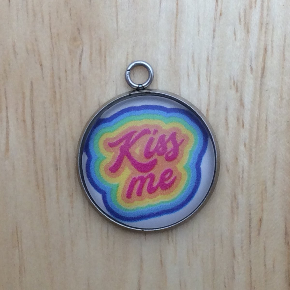 one glass cabochon charm that says Kiss me.